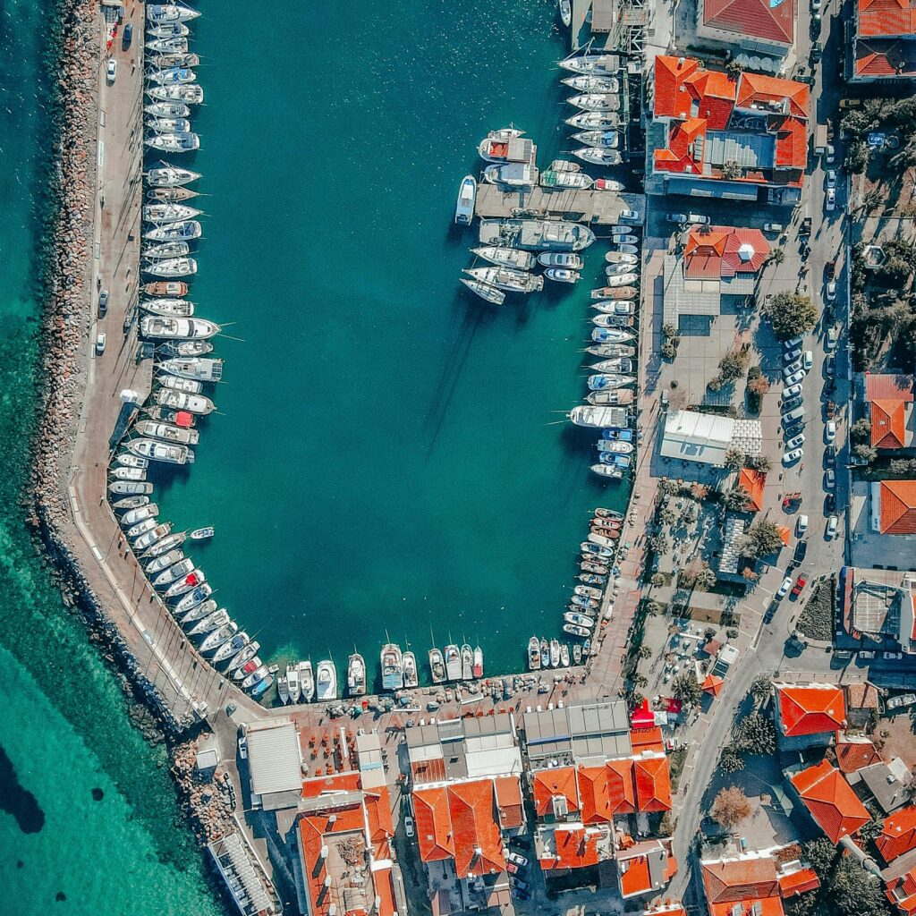 Stunning aerial shot of Urla Harbor, showcasing boats and vibrant coastline in İzmir, Türkiye.